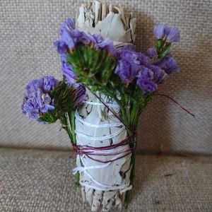 Burning sage dried flowers and calming essential oils